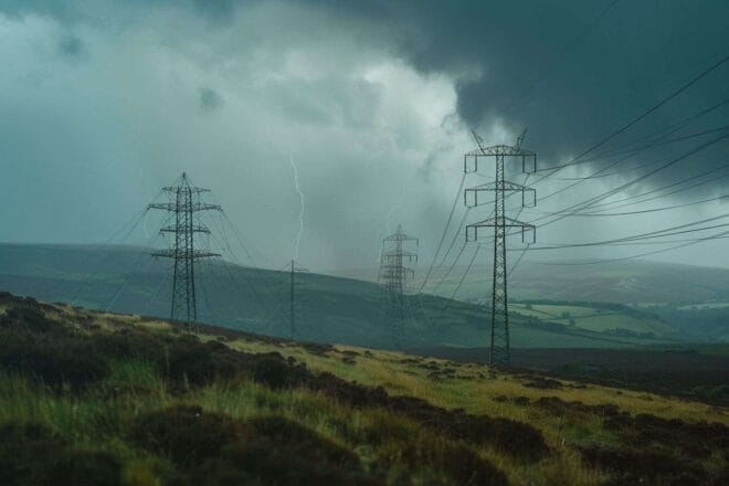 Vue panoramique des pylônes électriques sous un ciel orageux