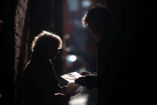 Figures ombragées échangeant des enveloppes