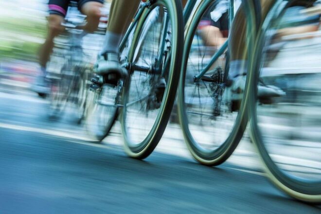 Gros plan des roues de vélo tournant rapidement pendant le Tour de France, capturant le mouvement et l'excitation.