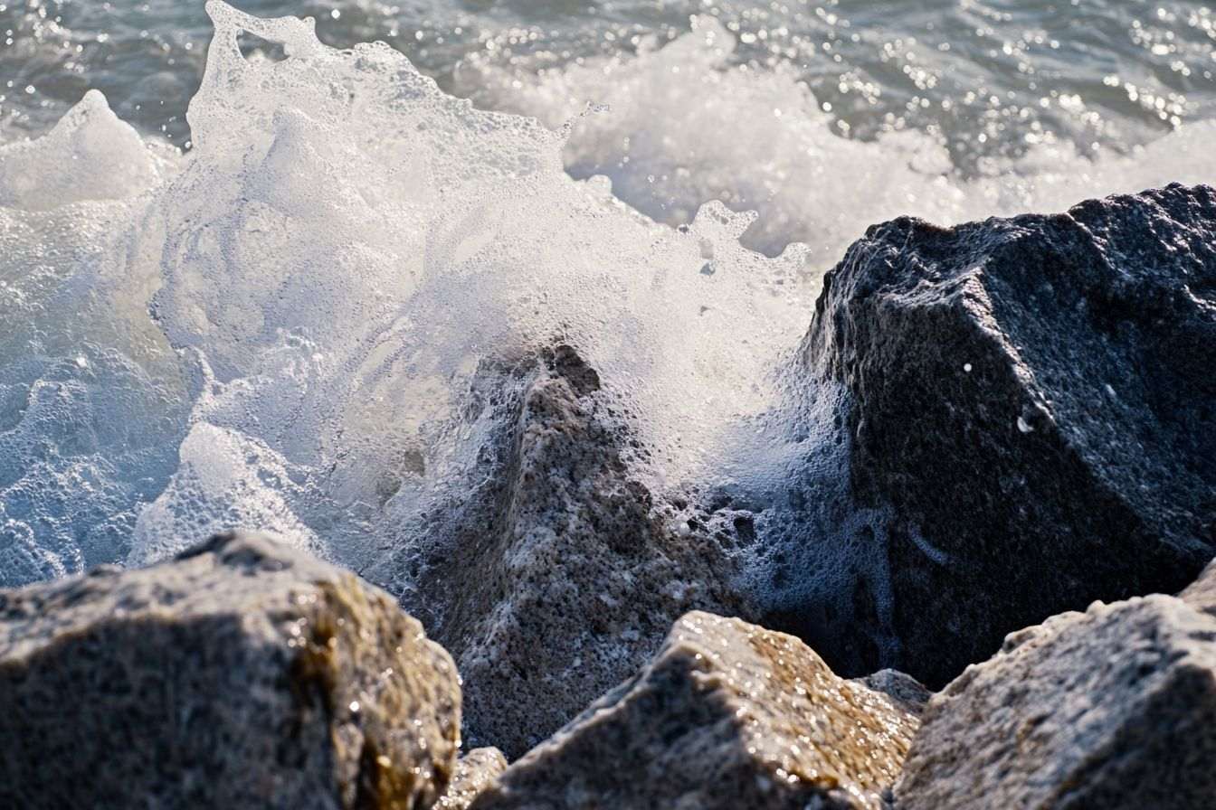 Gros plan d écume de mer autour de rochers acérés